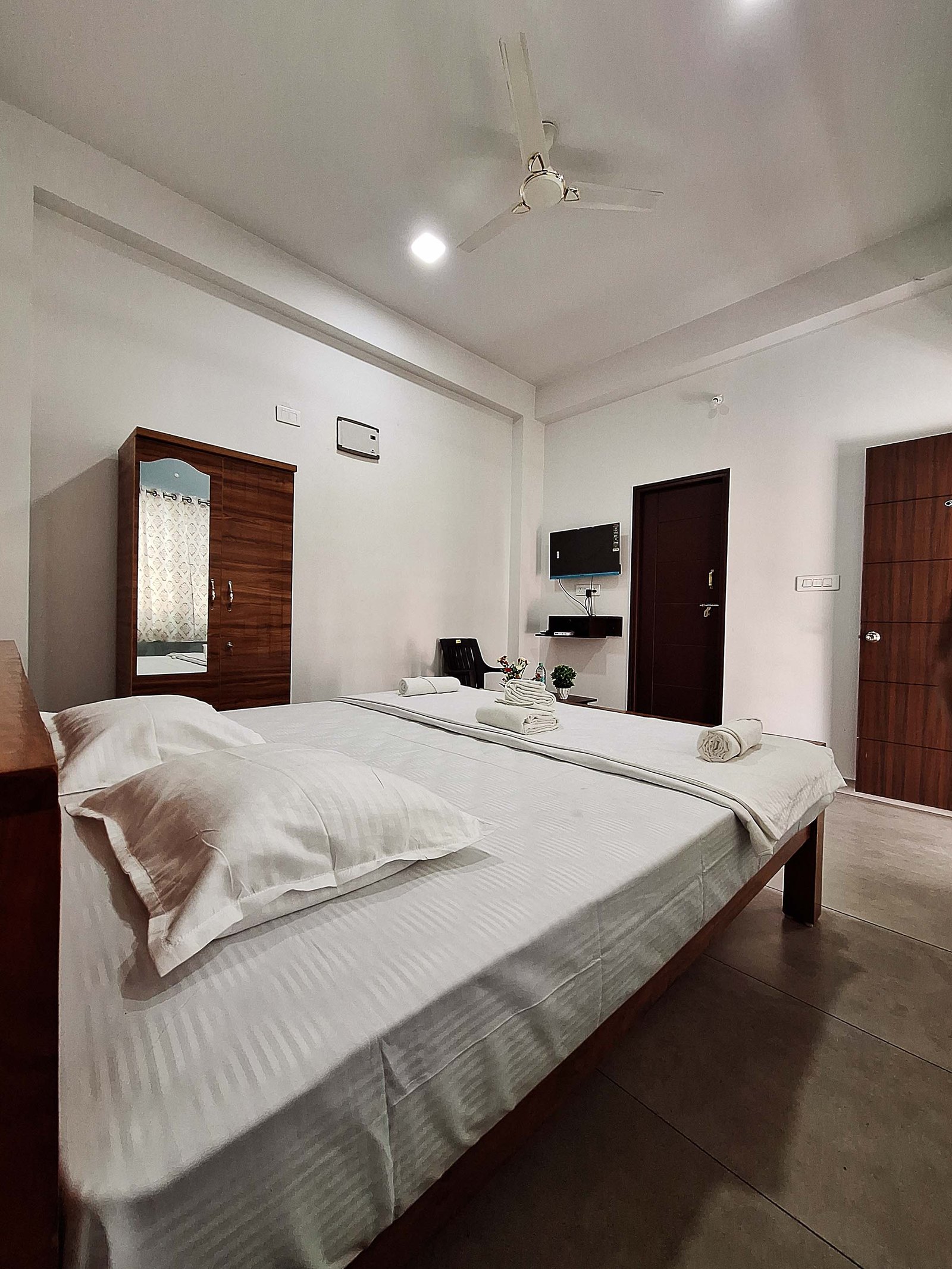 Positive young multiracial friends eating fast food and drinking beer in outdoor cafe