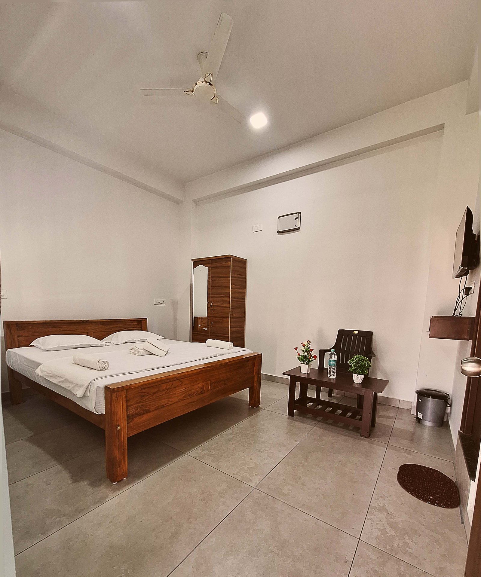 Burger with fried fries on black plate with sauce on the side